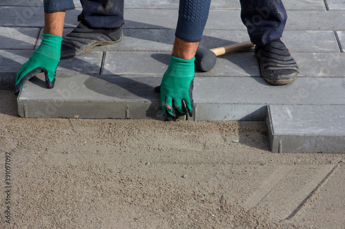 Brick Paver Working. Worker lay paving tiles, construction of brick pavement. Architecture background © Vasiliy Ulyanov