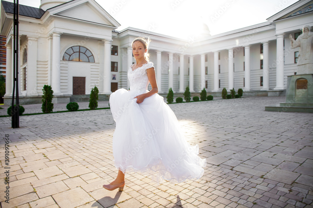 Fototapeta premium Portrait of a young woman in a white ball gown