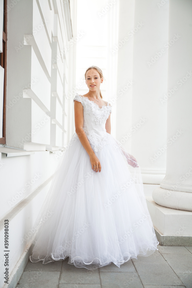 Portrait of a young woman in a white ball gown Portrait of a young woman in a white ball gown
