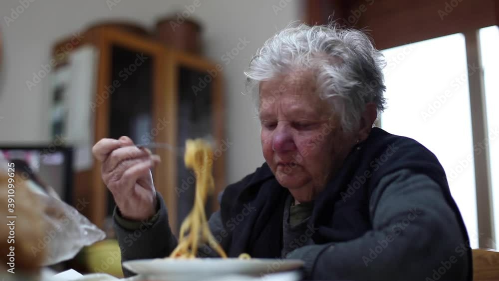 Senior Woman Eating Spaghetti at home. typical italian lunch Senior Woman Eating Spaghetti at home. typical italian lunch