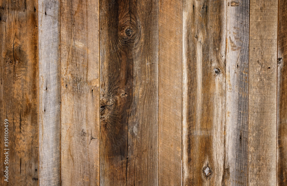Dark stained reclaimed wood surface with aged boards lined up. Wooden