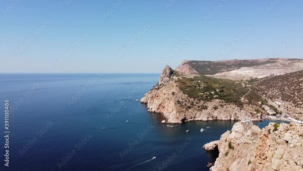 Cape and boats sailing on the sea. Cape and boats sailing on the sea.