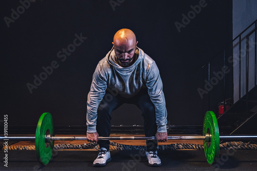 Personal trainer personal fitness coach body builder working in gym in blacj background photo