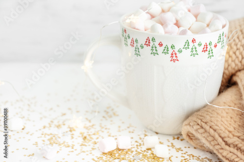 cup with hot chocolate and marshmallows close up on a white background