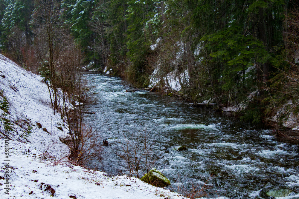Fototapeta premium Creek with flowing water and snow