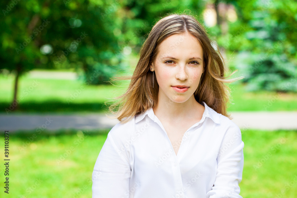 Portrait of a young beautiful brunette girl in summer park Portrait of a young beautiful brunette girl in summer park