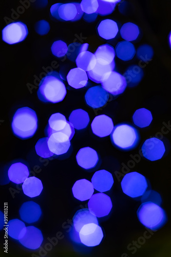Festive bokeh light abstract with blue blurred lights sparkling shiny shimmer vertical background