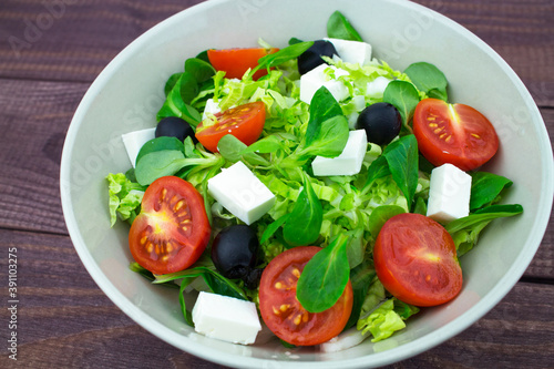 Salad, fresh tomatoes greens olives feta cheese. Classic Greek salad with fresh vegetables