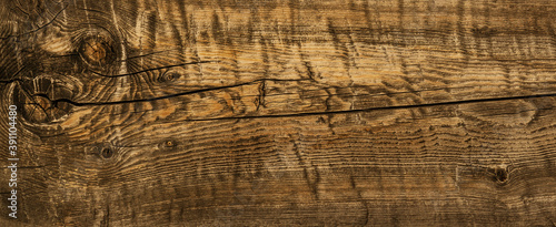 Dark stained reclaimed wood surface with aged dry texture. Vintage wood background.
