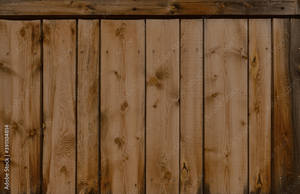 Dark stained reclaimed wood surface with aged boards lined up. Wooden