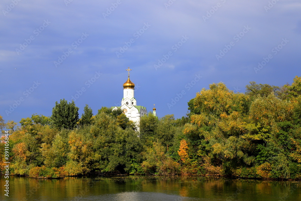 Beautiful autumn landscape on the Dnieper river, Christian church on the island among yellow trees, Ukraine city, Dnipro, Dnepropetrovsk, October, November.