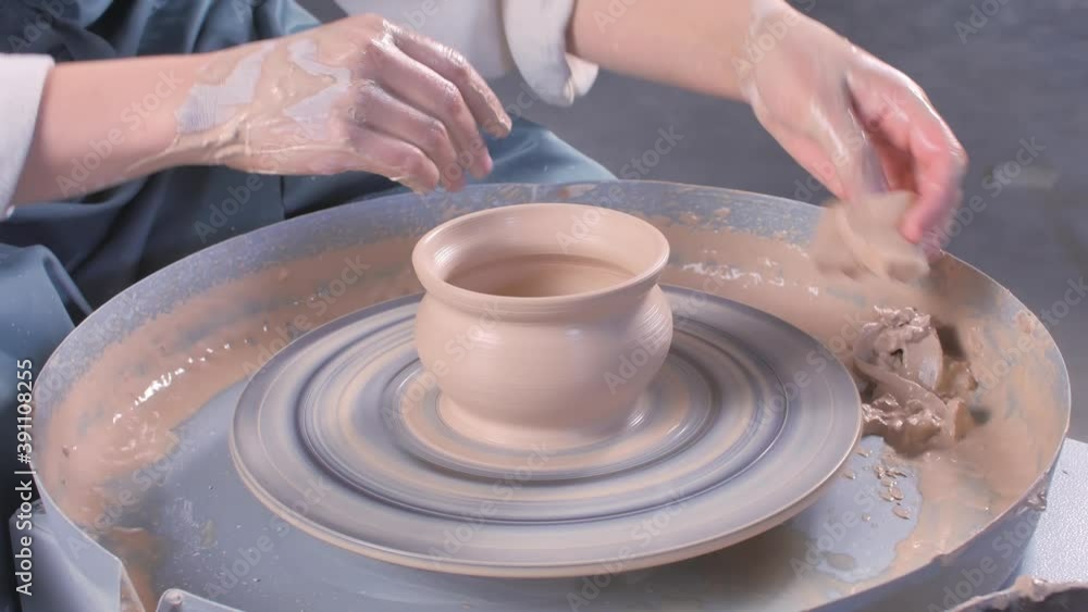 Potter craftsman sculptor works with clay on a Potter's wheel and at the table with the tools. The concept of craft creativity. Close-up. Potter craftsman sculptor works with clay on a Potter's wheel and at the table with the tools. The concept of craft creativity. Close-up.