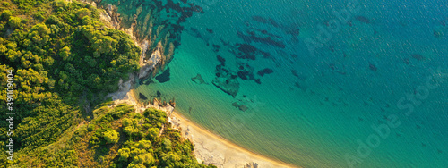 Aerial drone ultra wide panoramic photo of turquoise crystal clear beach in Skiathos island covered in pine trees, Sporades, Greece