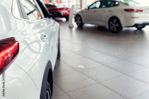 New white cars at dealer showroom with blurred background