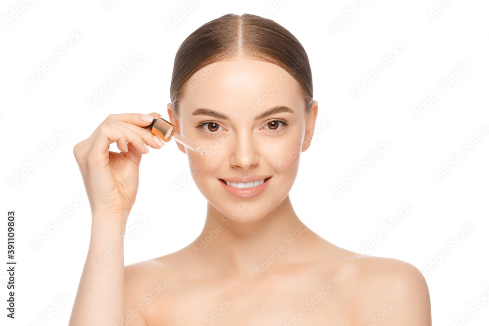 Young smiling beautiful female model holding pipette with cosmetic product or serum, ready to apply it, isolated on white background Young smiling beautiful female model holding pipette with cosmetic product or serum, ready to apply it, isolated on white background