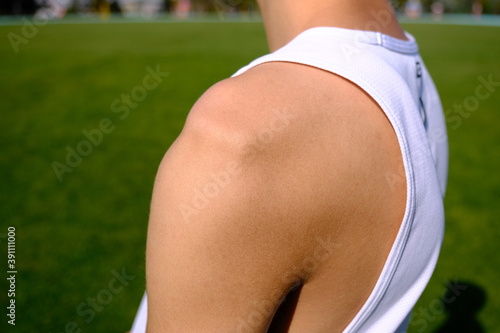 sportsman with shoulder dislocation in turf/sports field. shoulder bone is clarified.  photo