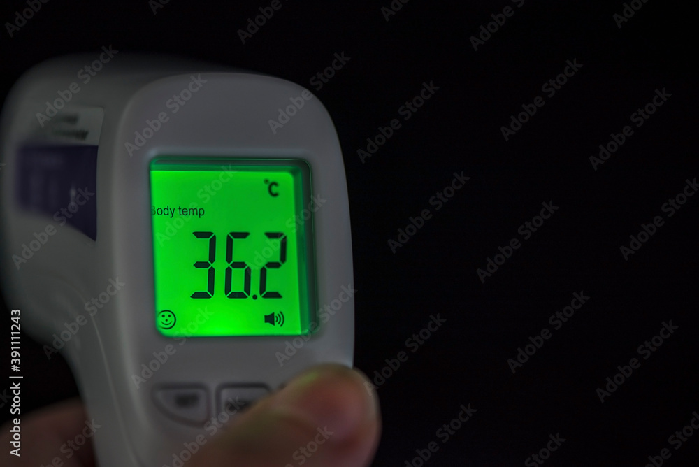 Infrared no touch thermometer monitor on a black background, isolated, close up Infrared no touch thermometer monitor on a black background, isolated, close up