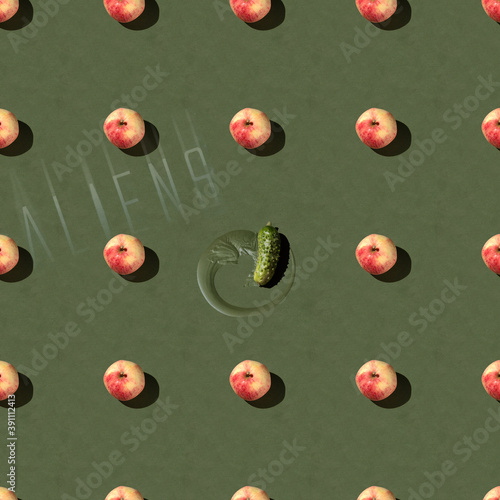 Фотография cucumber is alians in among the apples