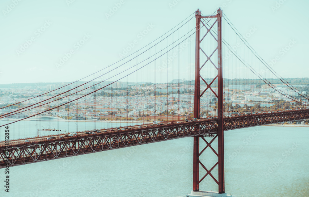 Fototapeta premium A suspension red rope bridge between Lisbon and Almada, Portugal named 