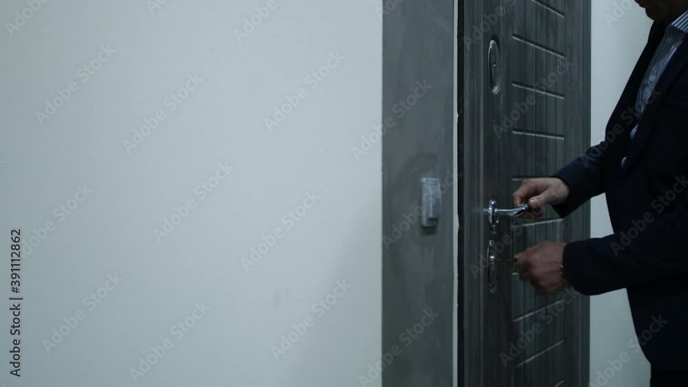 a man opens the front door a man opens the front door