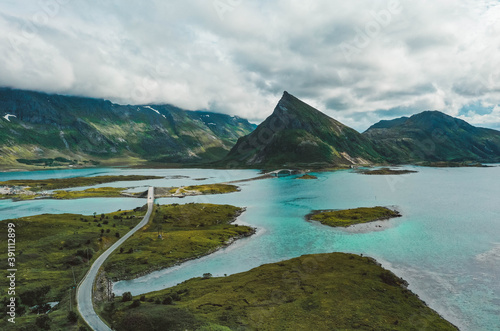 Road with bridges, islands, turquoise ocean and mountain peaks in Lofoten, Norway