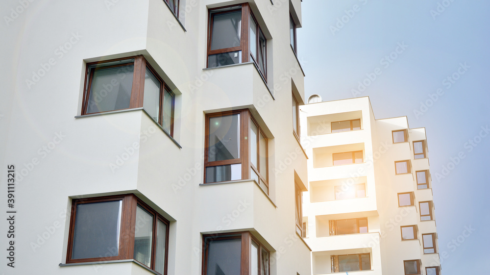 Exterior of a modern multi-story apartment building - facade, windows and balconies. Exterior of a modern multi-story apartment building - facade, windows and balconies.