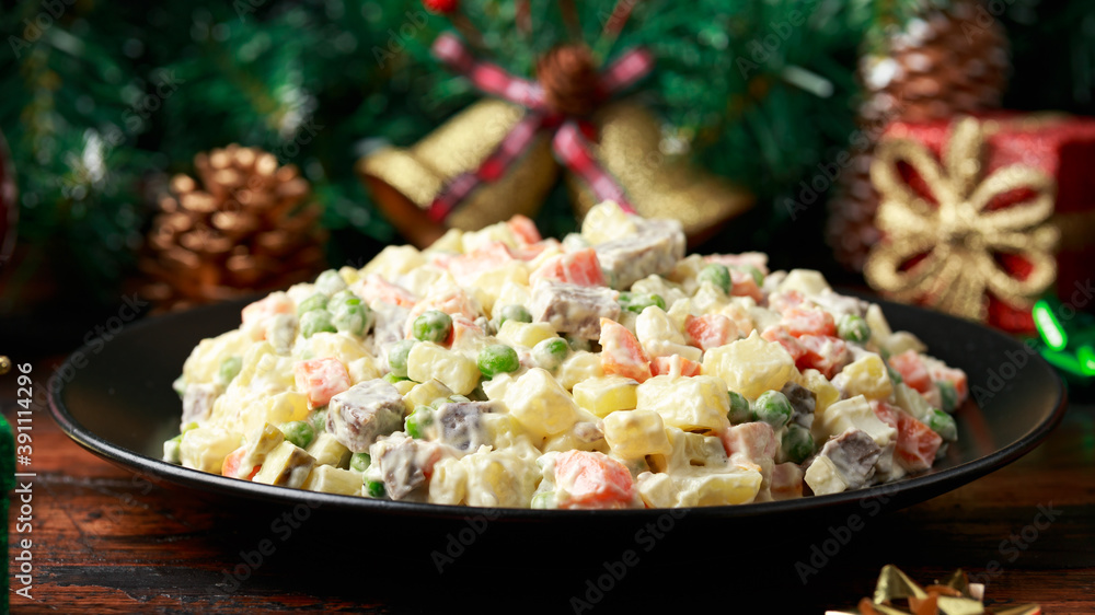 Christmas and New year Olivier salad, traditional Russian food with decoration, gifts, green tree branch on wooden rustic table Christmas and New year Olivier salad, traditional Russian food with decoration, gifts, green tree branch on wooden rustic table