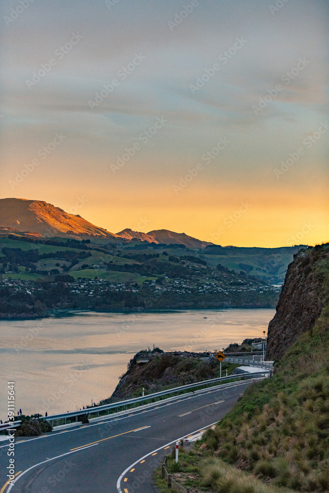 Sunset over a mountain range with a fjord in New Zealand Sunset over a mountain range with a fjord in New Zealand