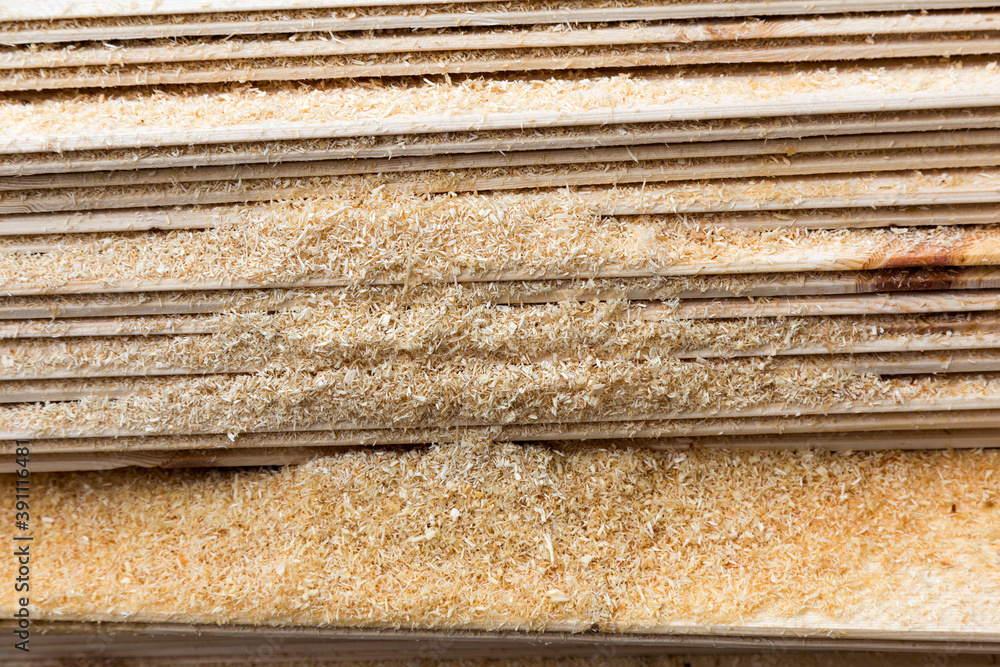 Planed boards, lining, lie horizontally, covered with sawdust. Planed boards, lining, lie horizontally, covered with sawdust.