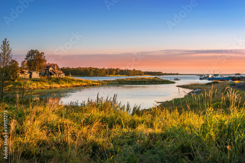 Wooden house on the shore of the bay in the White Sea on the Solovetsky Islands © yulenochekk