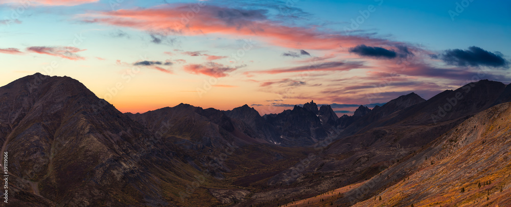Aerial Panoramic View of Scenic Landscape and Mountains on a Cloudy Fall Season in Canadian Nature. Colorful Twilight Sky Artistic Render. Taken in Tombstone Territorial Park, Yukon, Canada.