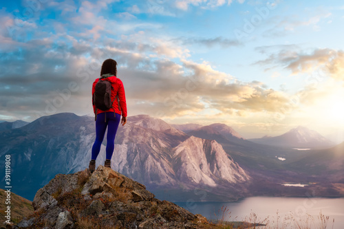 Adventurous Girl Hiking up the Nares Mountain. Dramatic Colorful Sunrise Sky Art Render. Taken near Whitehorse, Yukon, Canada.