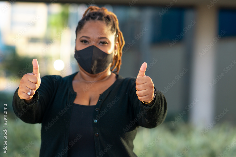 African woman wearing mask thumbs up African woman wearing mask thumbs up