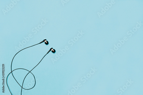 Wired headphones on a blue background