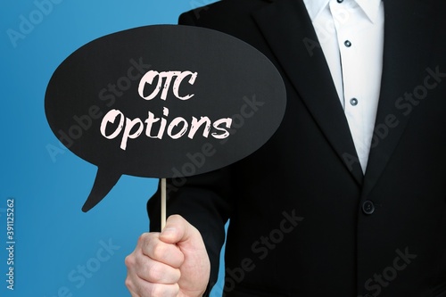 OTC Options. Businessman holds speech bubble in his hand. Handwritten Word/Text on sign. photo