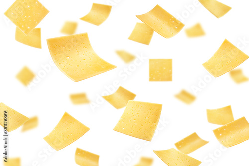 Falling cheese slices, isolated on white background, selective focus