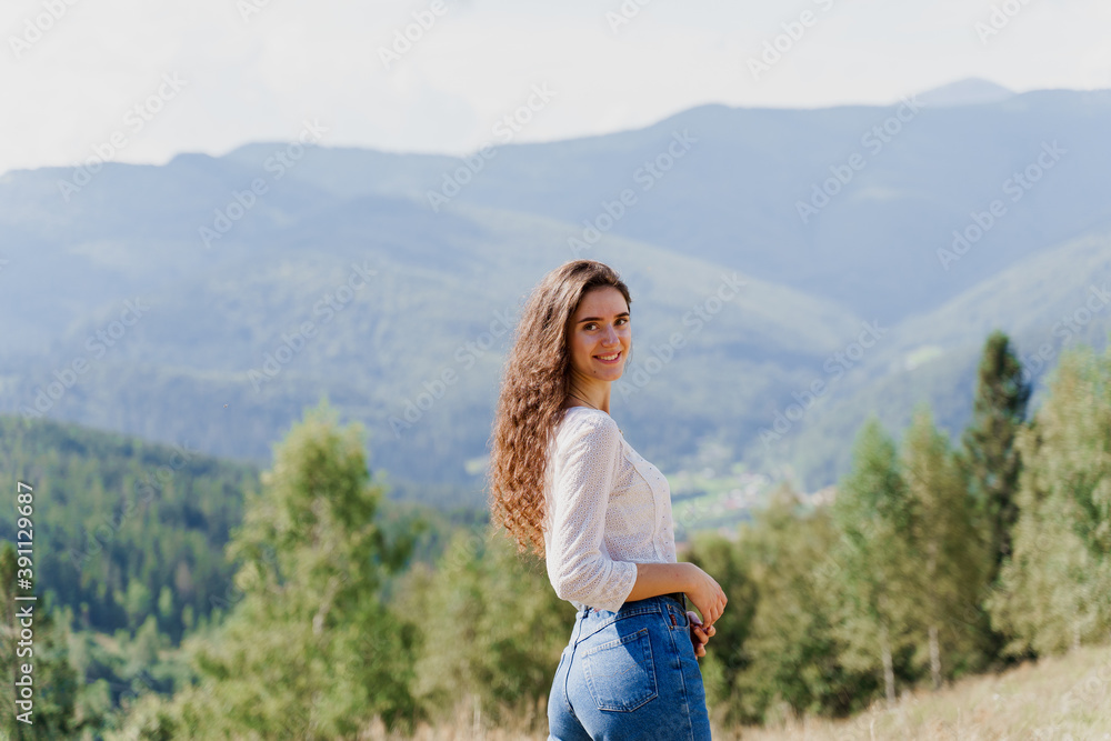 Girl enjoying the mountain hills view. Feeling freedom in Karpathian mountains. Tourism travelling in Ukraine.