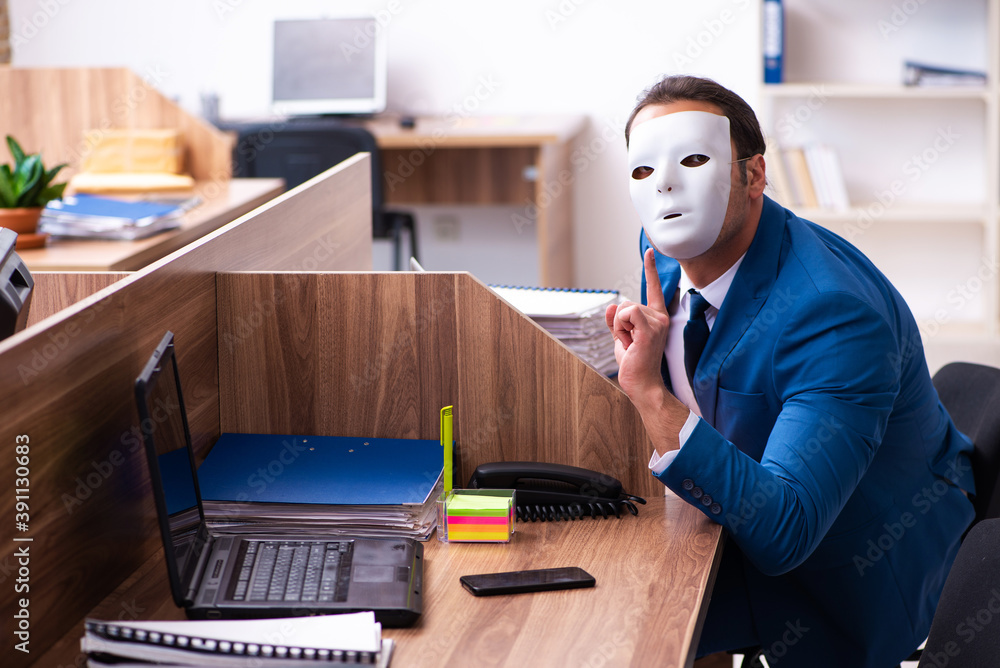 Young male employee wearing mask in the office Young male employee wearing mask in the office