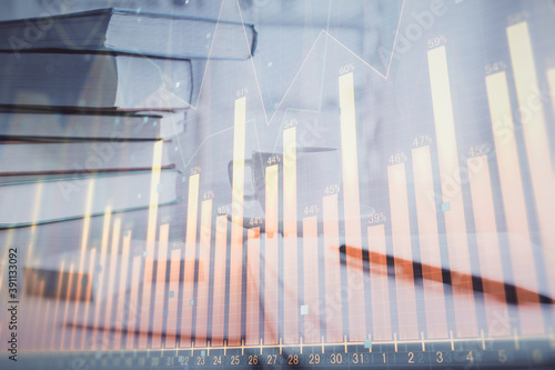 Double exposure of financial chart drawing and desktop with coffee and items on table background. Concept of forex market trading