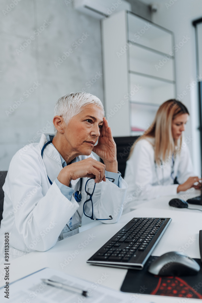 Senior and young female doctors working in their office. Healthcare concept. Senior and young female doctors working in their office. Healthcare concept.