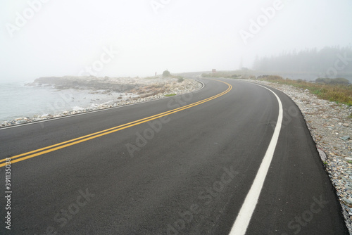 road near beach in the fog
