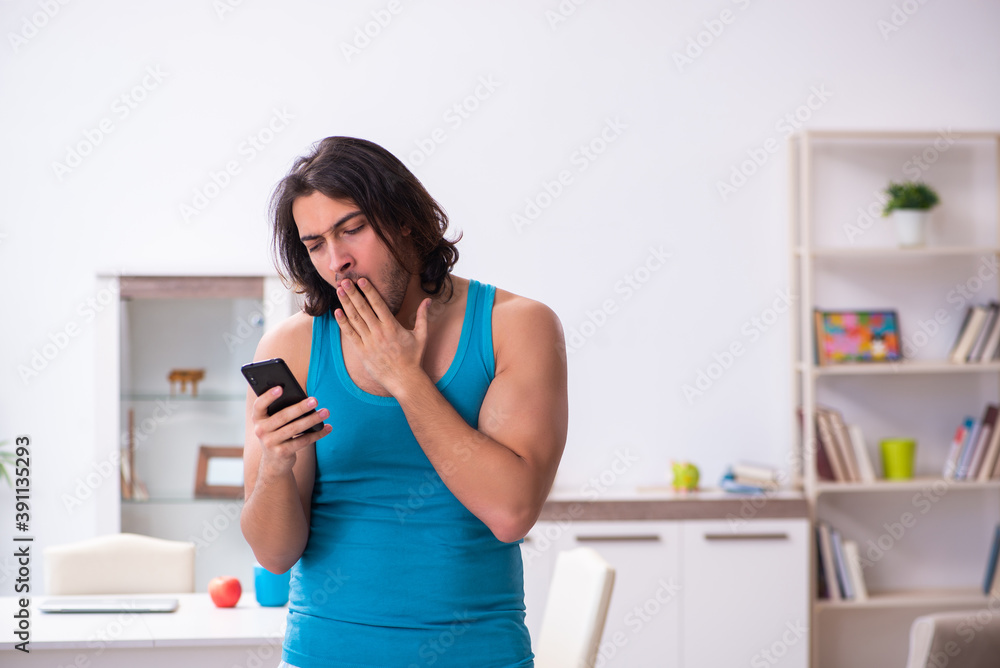 Young man waking up at home Young man waking up at home