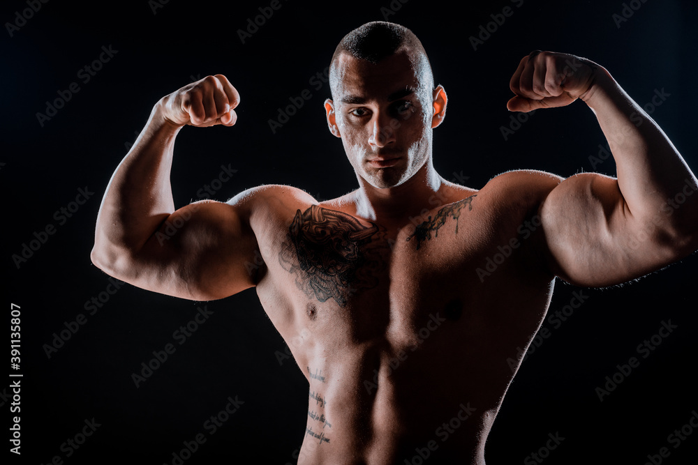 Young muscular guy in the studio, posing for the camera