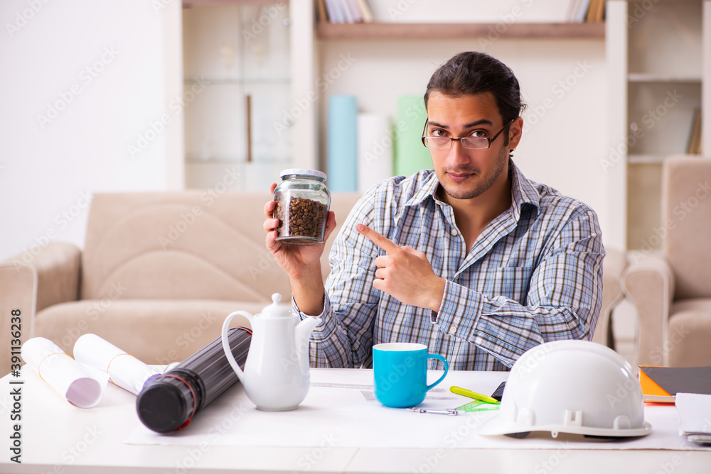 Young male architect working from house during pandemic Young male architect working from house during pandemic