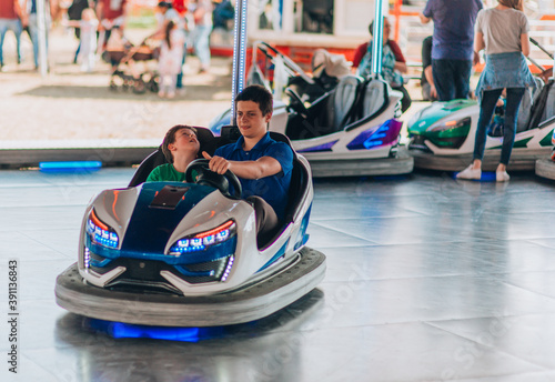 Two brothers in amusement park ride fun concept