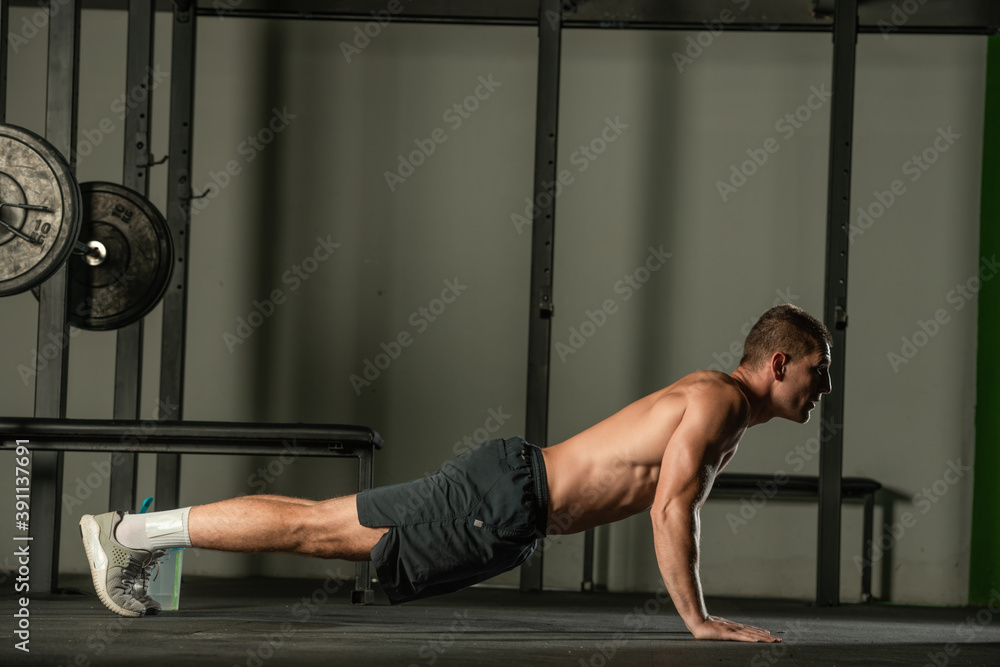 Strong male athlete doing push-ups indoors. Close up perspective, healthy lifestyle, fatless body. Strong male athlete doing push-ups indoors. Close up perspective, healthy lifestyle, fatless body.