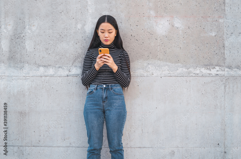 Asian woman using her mobile phone. Asian woman using her mobile phone.