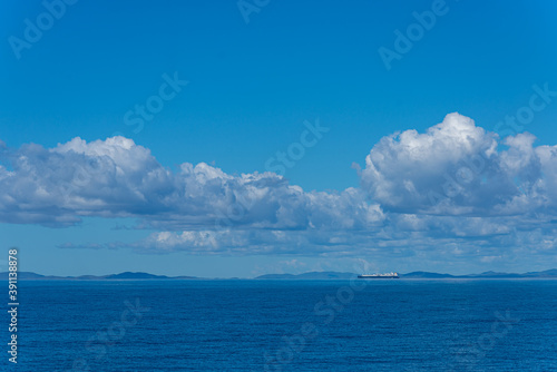 Ship with islands in background on Coral Sea