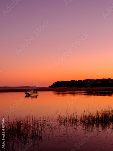 Sunset Silhouette Seascape with Moored Boat in the Tranquil Bay