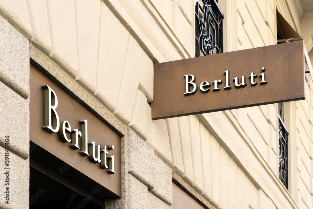 Street hanging mounted on the wall. Signboard for logo presentation.  Berluti, part of the LVMH group